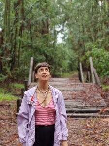 Woman looking up in a forest